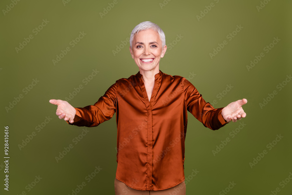 Photo portrait of lovely pensioner lady welcome stretch hands dressed stylish brown formalwear isolated on khaki color background Photo portrait of lovely pensioner lady welcome stretch hands dressed stylish brown formalwear isolated on khaki color background