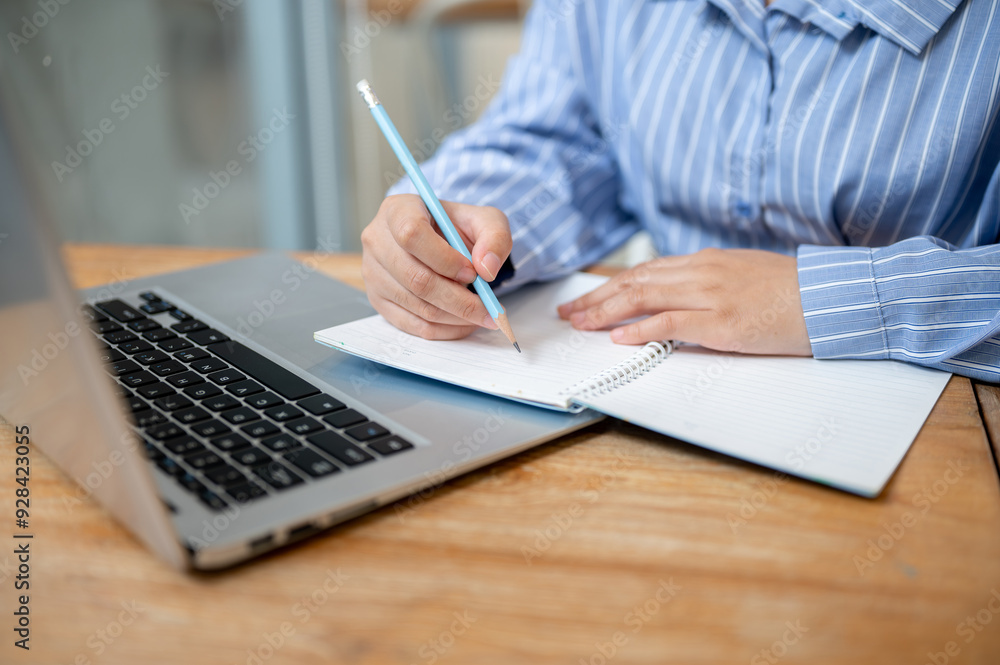 A cropped image of a woman lecturing an online meeting in a book, working remotely from a cafe. A cropped image of a woman lecturing an online meeting in a book, working remotely from a cafe.