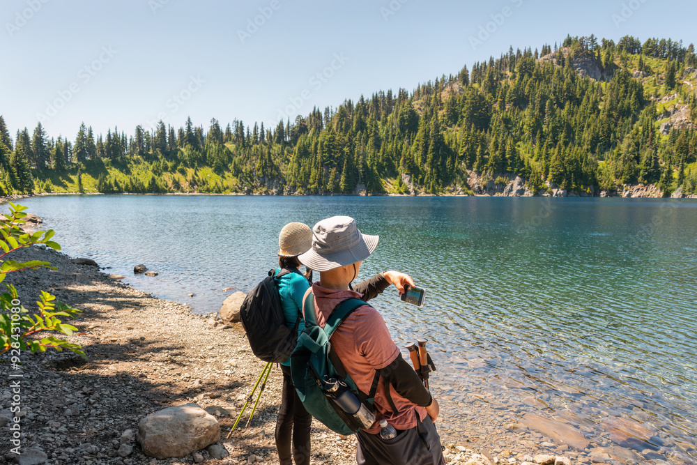 Tourists taking photos using smartphones. Summit Lake. Mount Rainier National Park. Washington State.