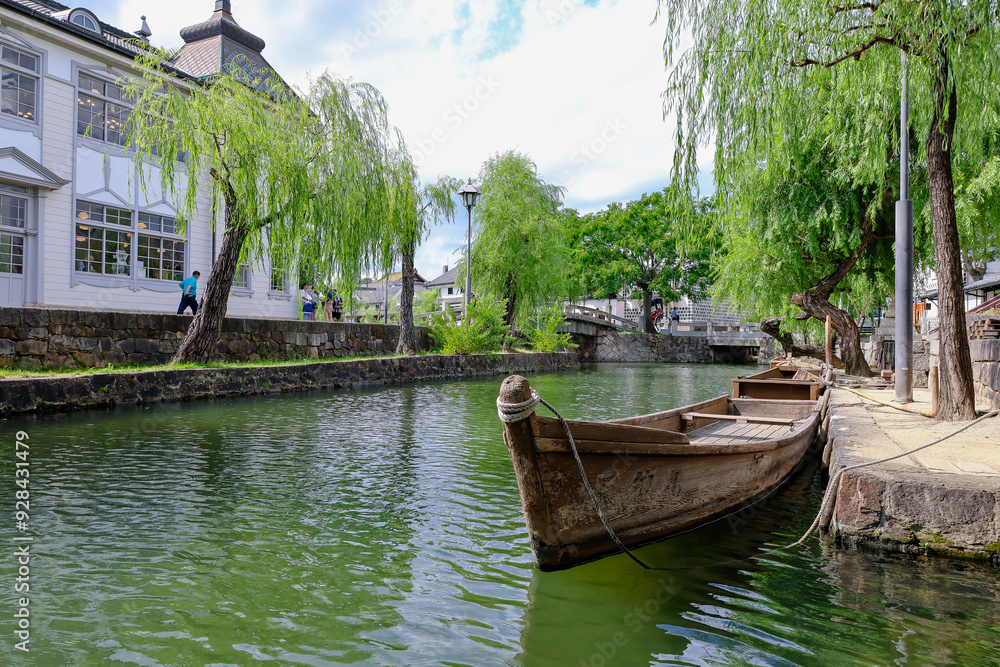 A rowboat is anchored in the Kurashiki Canal. A rowboat is anchored in the Kurashiki Canal.