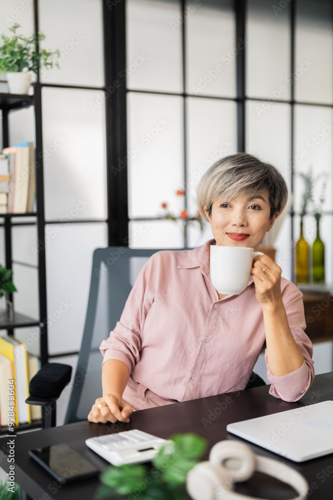 aged businesswoman with short gray hair is seated at her desk, looking thoughtfully upward while resting her chin on her hand in a modern, stylish office aged businesswoman with short gray hair is seated at her desk, looking thoughtfully upward while resting her chin on her hand in a modern, stylish office