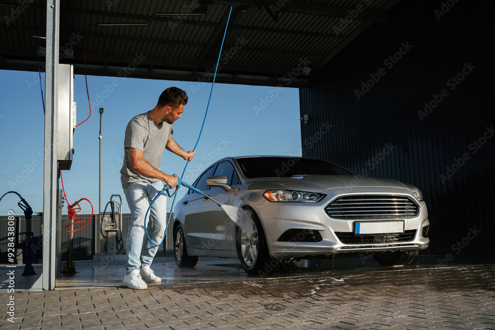 Service of car wash. Man is with his automobile outdoors Service of car wash. Man is with his automobile outdoors