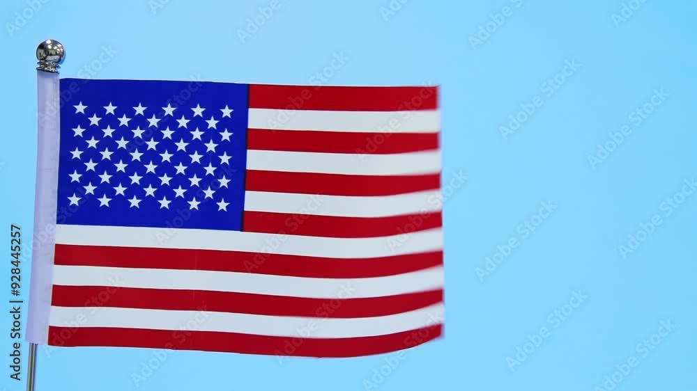 American flag waving on blue background, slow motion American flag waving on blue background, slow motion