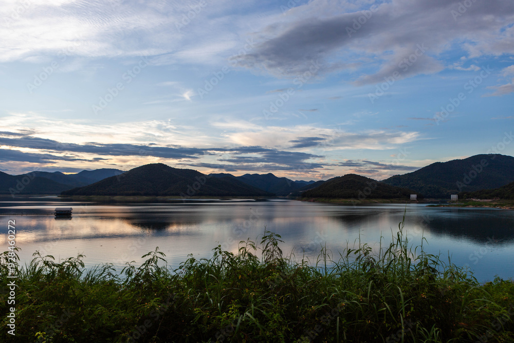 Mae Kuang reservoir. Beautiful lake and mountains landscape at sunset in Chiang Mai province, Northern Thailand. View to suspension bridge. Mae Kuang reservoir. Beautiful lake and mountains landscape at sunset in Chiang Mai province, Northern Thailand. View to suspension bridge.