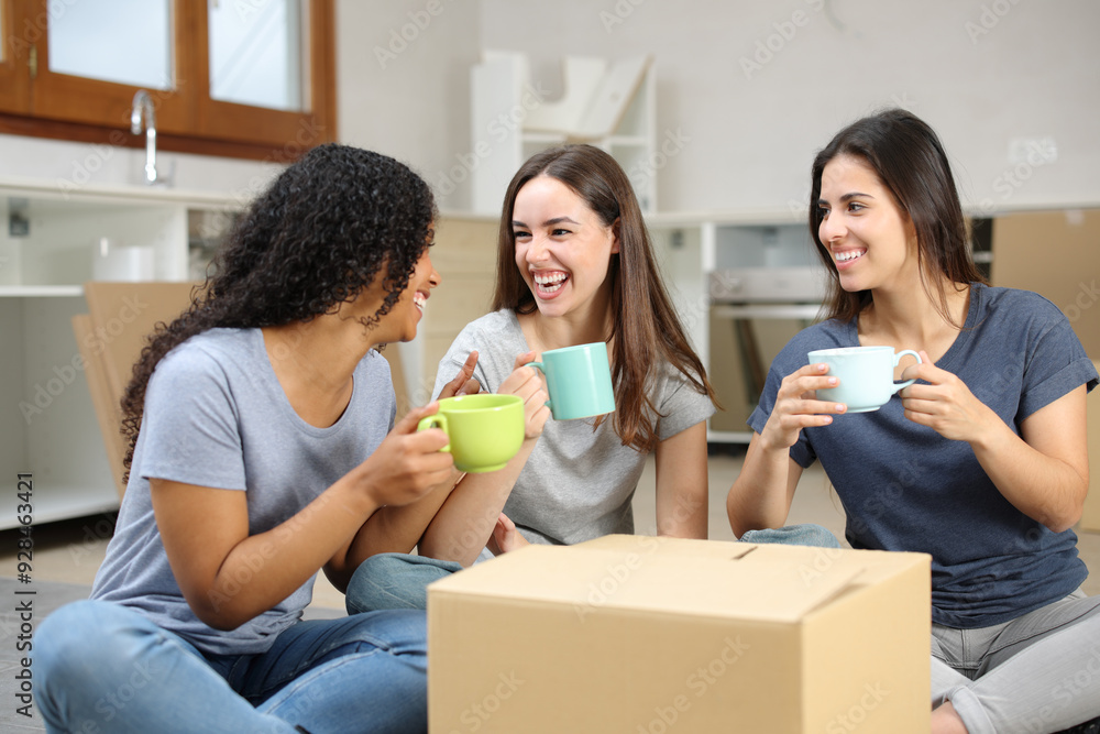 Three happy roommates talking and resting moving home Three happy roommates talking and resting moving home