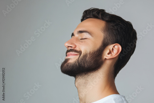 A close up of a man's face with his eyes closed