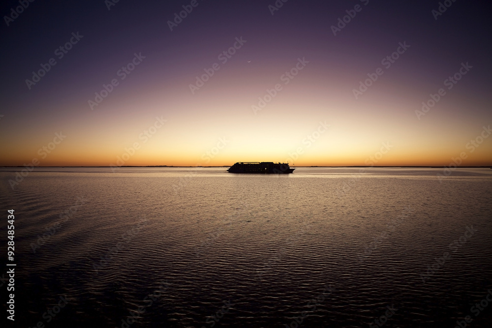 Lake Nasser cruise ship from Abu Simbel to Aswan at sunset with moon, Egypt Lake Nasser cruise ship from Abu Simbel to Aswan at sunset with moon, Egypt
