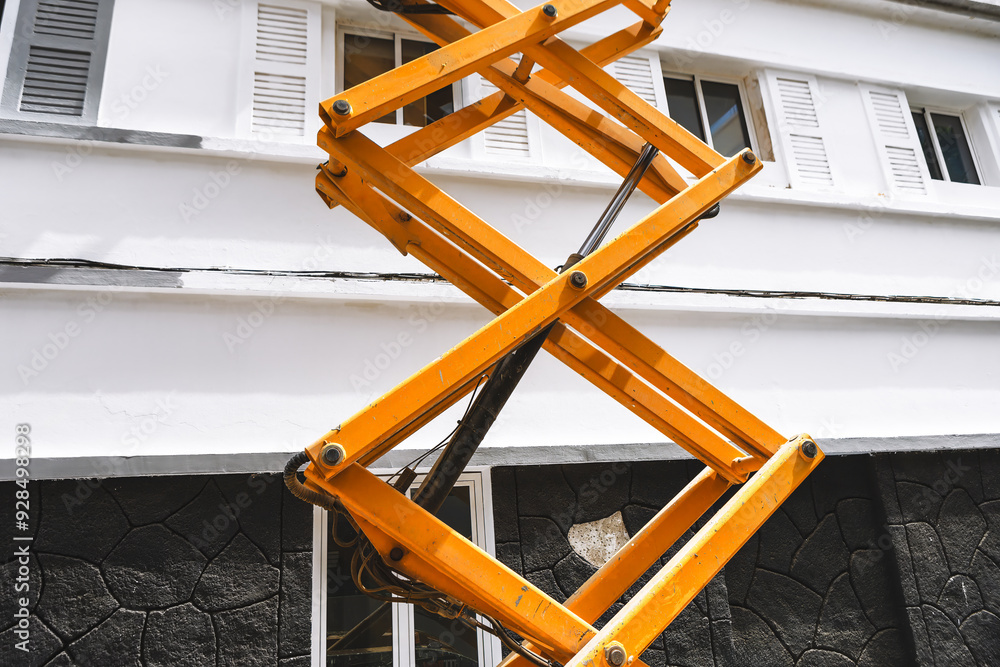 Scissor lift positioned on the roof of a building, ready for ...