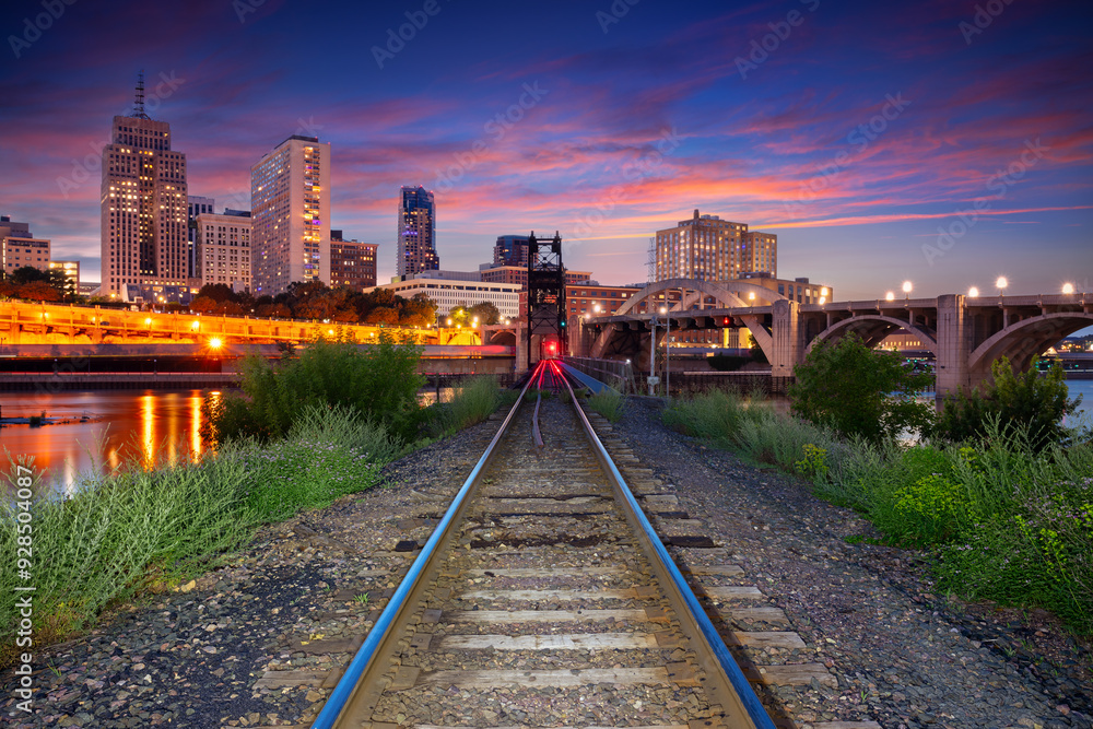 Saint Paul, Minnesota, USA. Cityscape image of downtown St. Paul, Minnesota, USA with railway tracks leading to the city at beautiful summer sunset.