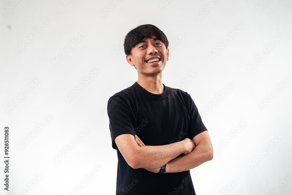 A smiling Asian man in a black t-shirt stands confidently with arms crossed against a plain white background, ideal for professional headshots, personal branding, or business profile content A smiling Asian man in a black t-shirt stands confidently with arms crossed against a plain white background, ideal for professional headshots, personal branding, or business profile content