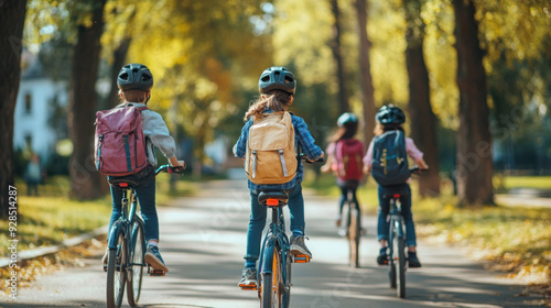 Fototapeta Naklejka Na Ścianę i Meble -  Active  children cycling through a park on a sunny day