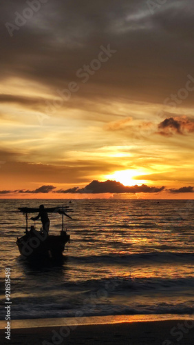 Silhouette people in the boat against sunset at the beach 