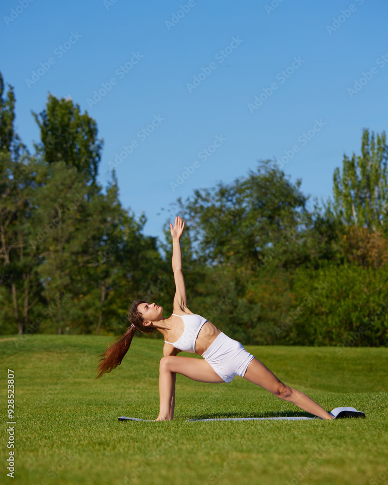 Woman practices yoga, integrating deep stretches with meditation, promoting her physical flexibility and strength. Concept of mental and physical health, recreation, balance, nature.