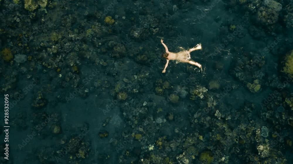 Drone Aerial View of Woman Swimming in Crystal Clear Ocean Water - Serene Summer Vacation in Tropical Paradise.