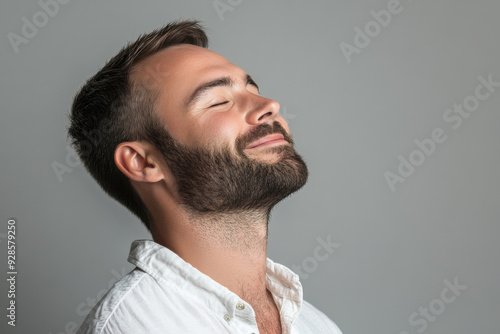 A close up of a man's face with his eyes closed