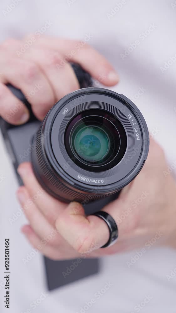 Vertical close up of person change aperture using lens ring, digital camera Vertical close up of person change aperture using lens ring, digital camera