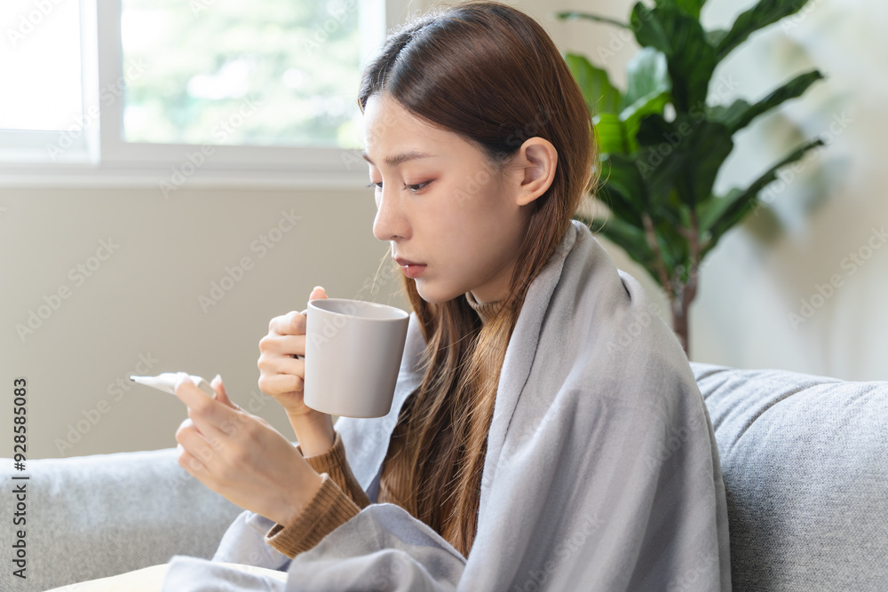 Woman measuring temperature her body on the bed. person got fever lying on the bed Woman measuring temperature her body on the bed. person got fever lying on the bed