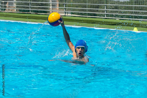 Water polo player with a yellow ball
