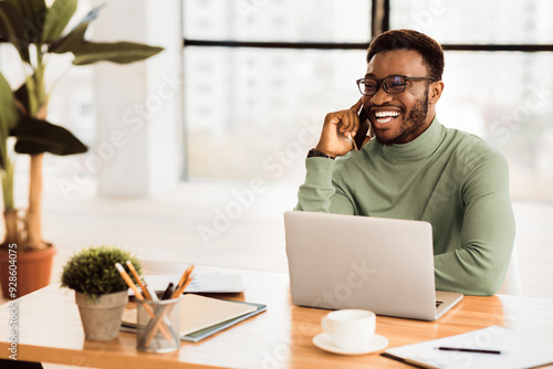 Phone Consultation. Millennial black man talking to client on mobile phone and smiling, copy space