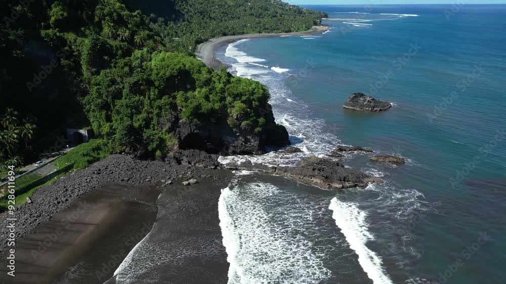 A rocky coastline on anjouan island with lush green cliffs and turquoise waters, aerial view A rocky coastline on anjouan island with lush green cliffs and turquoise waters, aerial view