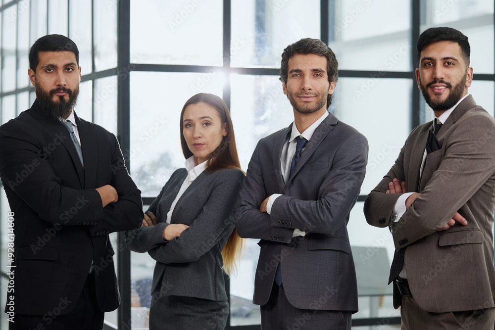 Portrait of four office workersr arms over their chest. Portrait of four office workersr arms over their chest.