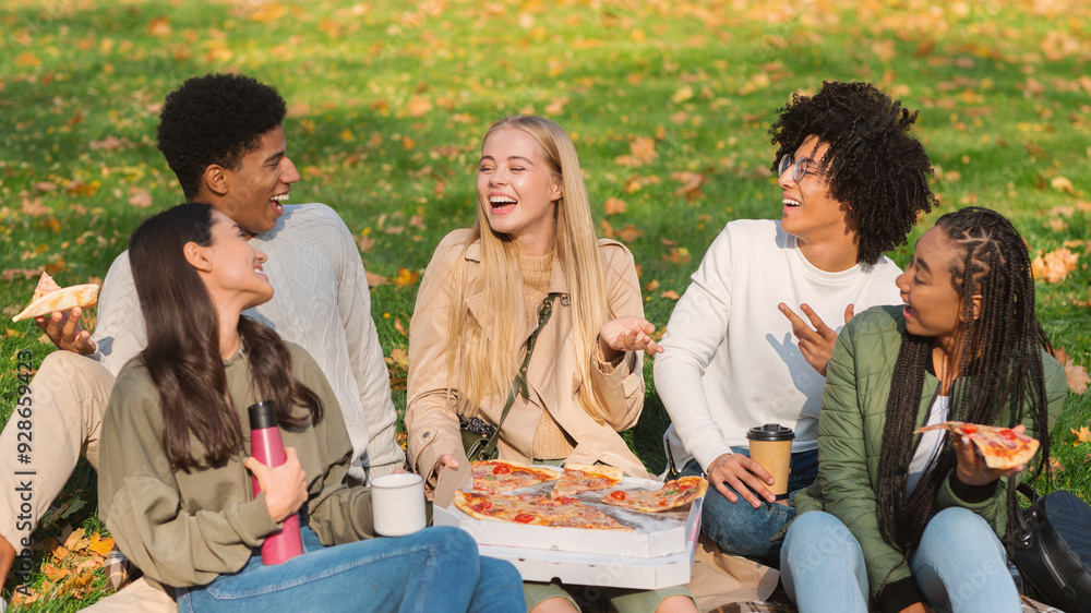 Cheery international students sharing their stories while eating pizza at park Cheery international students sharing their stories while eating pizza at park