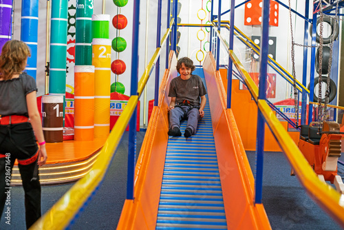 happy boy on a sports hill in a training hall. Active family recreation photo