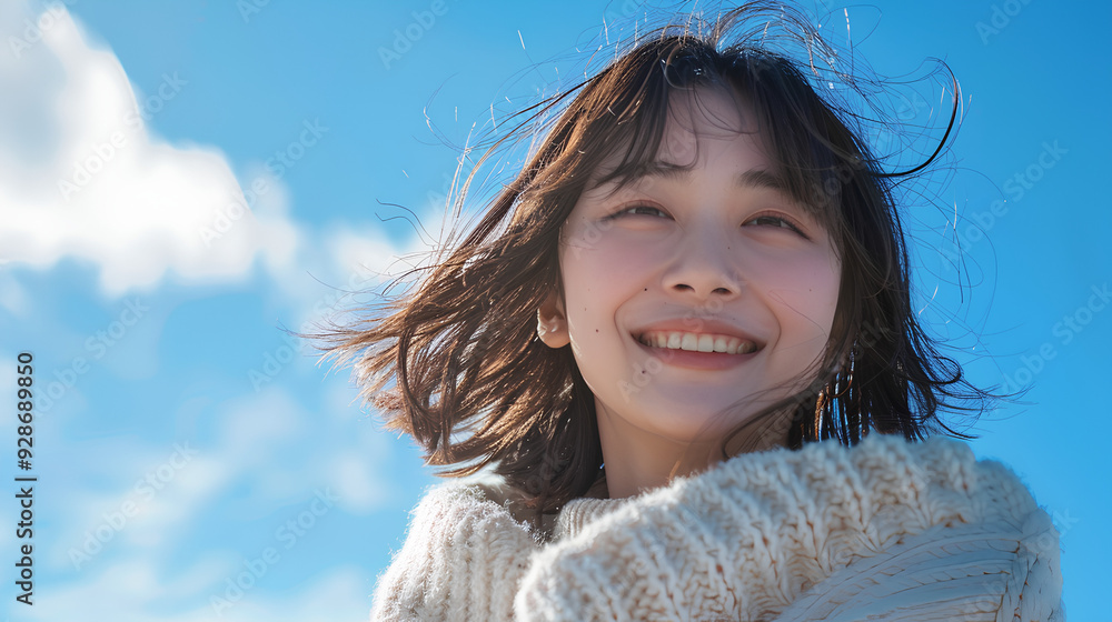 Beautiful Asian Korean woman with her smile on a sky blue background Beautiful Asian Korean woman with her smile on a sky blue background