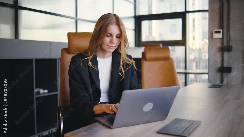 A professional woman is engaged in her work on a laptop within a modern office setting, showcasing the synergy between technology and innovation in todays business world A professional woman is engaged in her work on a laptop within a modern office setting, showcasing the synergy between technology and innovation in todays business world