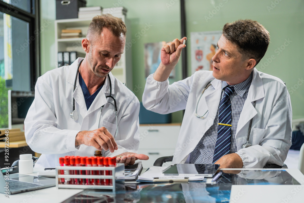 Caucasian middle-aged male doctor and Italian scientific researcher are seated at desk, discussing innovative antiviral drug inventions, with a monitor displaying the latest technology advancements. Caucasian middle-aged male doctor and Italian scientific researcher are seated at desk, discussing innovative antiviral drug inventions, with a monitor displaying the latest technology advancements.