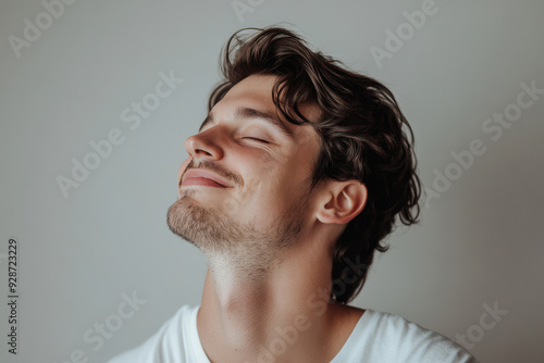 A close up of a man's face with his eyes closed