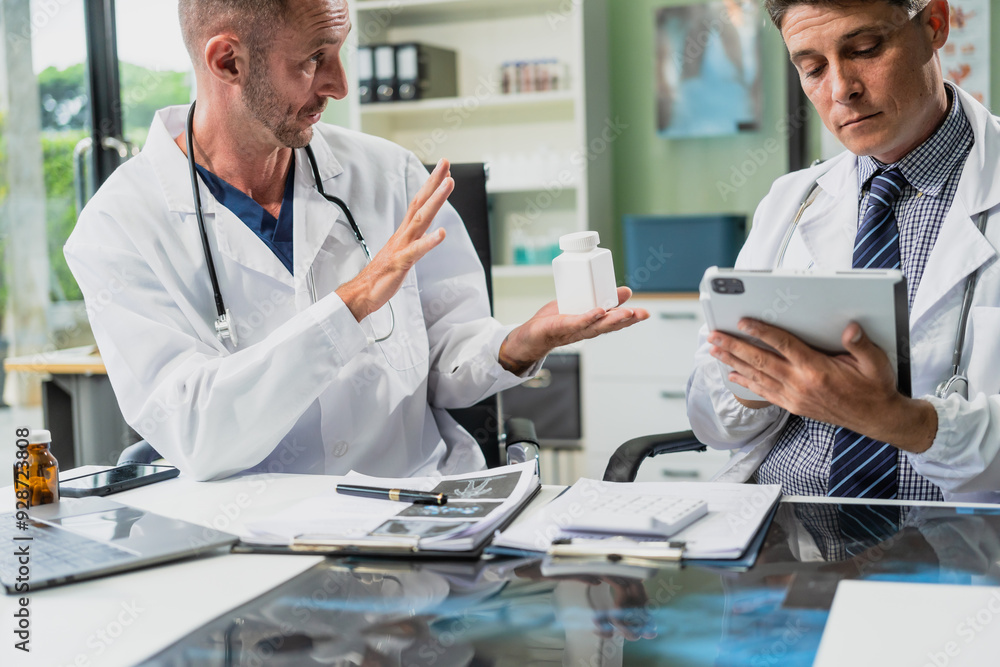 Caucasian middle-aged male doctor and Italian scientific researcher are seated at desk, discussing innovative antiviral drug inventions, with a monitor displaying the latest technology advancements. Caucasian middle-aged male doctor and Italian scientific researcher are seated at desk, discussing innovative antiviral drug inventions, with a monitor displaying the latest technology advancements.