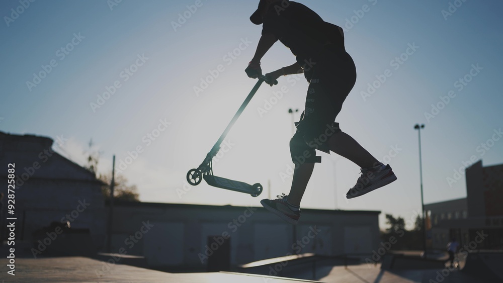 Naklejka premium guy riding a skateboard. city landscape glare of the sun. height extreme. brave guy jumping high on a skateboard. daytime city. form content lifestyle