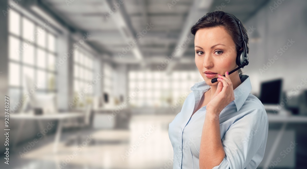 Smiling business person with headset working in a call center Smiling business person with headset working in a call center