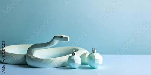 Obraz na płótnie A stylish minimalist image of a white geometric snake on a blue background. Light blue herringbone balls with a multifaceted texture. Festive New Year card, New Year and Christmas project. Minimalism w salonie
