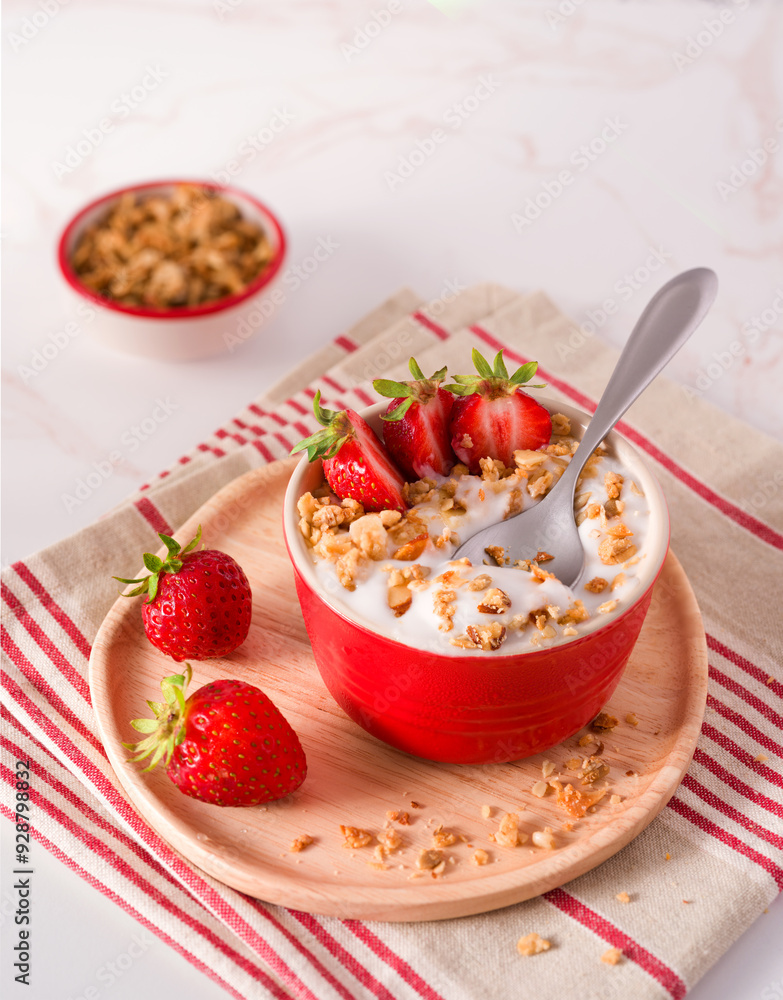 Plant-based non-dairy coconut yogurt topped with granola and strawberries; copy space; plant-based diet Plant-based non-dairy coconut yogurt topped with granola and strawberries; copy space; plant-based diet