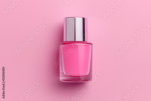 Elegant pink nail polish bottle with silver cap on a soft pastel pink background, perfect for beauty and fashion themes.