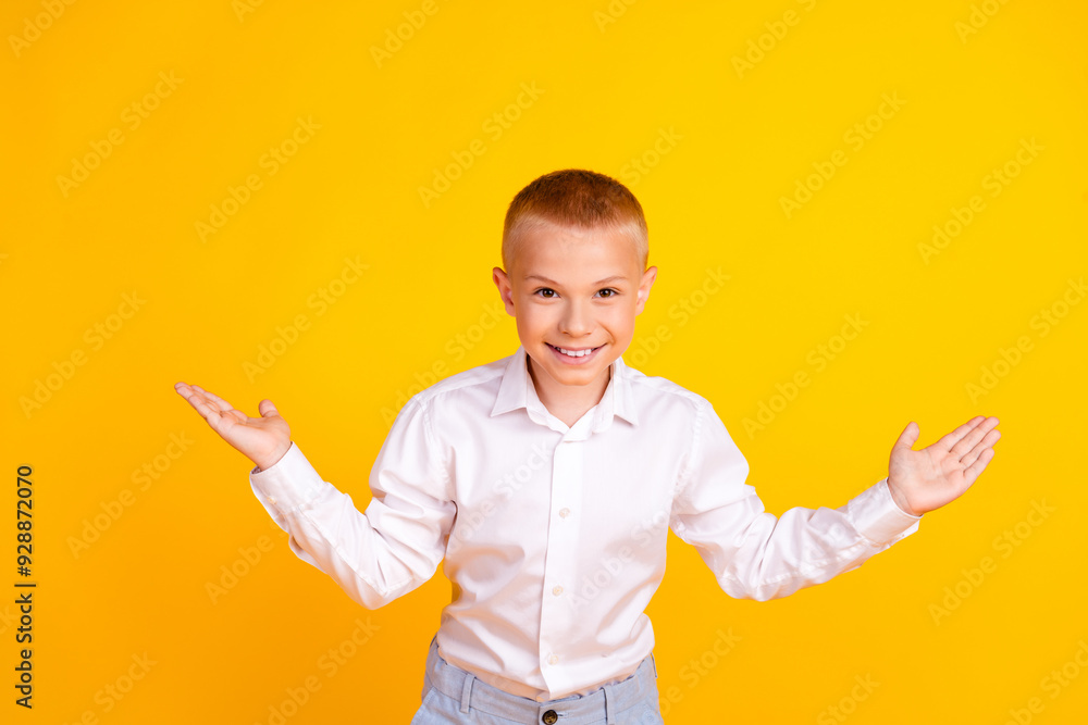 Photo of charming positive clever boy wear white shirt clothes isolated on yellow color background Photo of charming positive clever boy wear white shirt clothes isolated on yellow color background