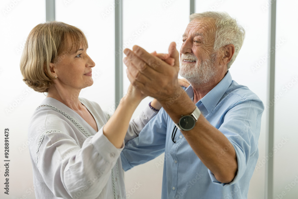 Mature couple dancing together at home Mature couple dancing together at home