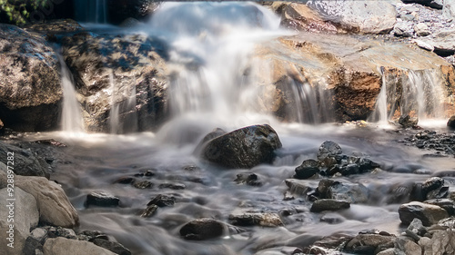 Mountain Stream Flows Over Rocks, Creating A Silky Smooth Effect With The Water