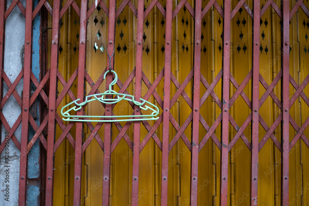 Cloth hanger hanging on the shutter metal door