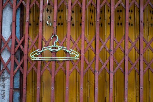 Obraz na płótnie Cloth hanger hanging on the shutter metal door w salonie