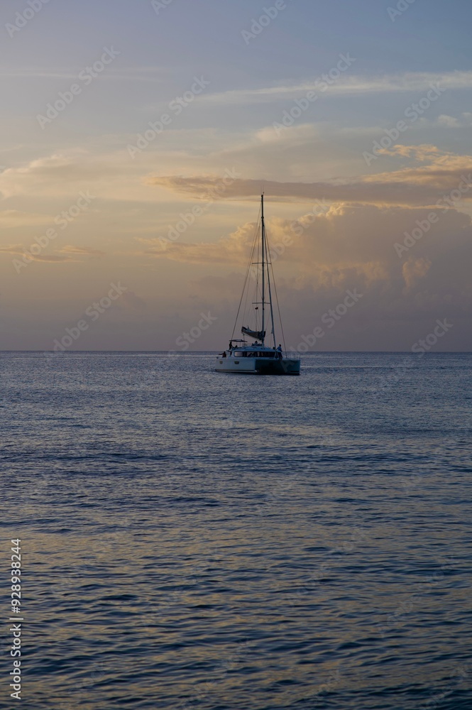 Serene sailboat on calm ocean waters at sunset. Serene sailboat on calm ocean waters at sunset.