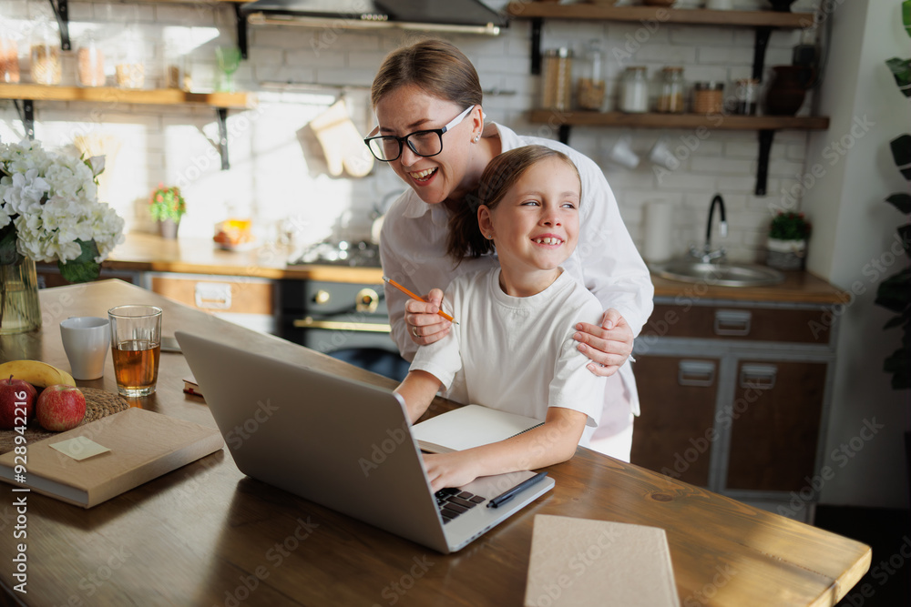Cheerful mother and daughter using laptop during online education at home Cheerful mother and daughter using laptop during online education at home