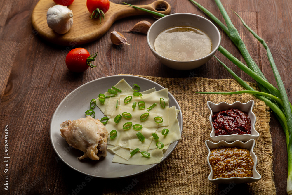 Dagestan khinkal thin dough, meat, meat broth, with mustard and adjika on the table Dagestan khinkal thin dough, meat, meat broth, with mustard and adjika on the table