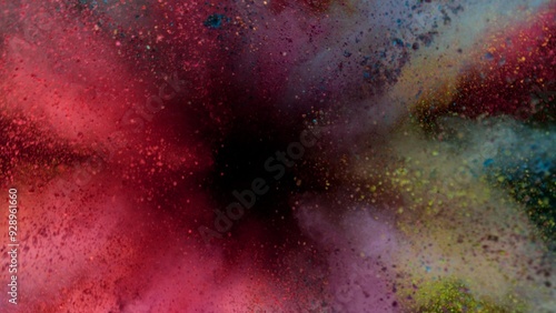 Colored powder explosion on black background . Freeze motion.