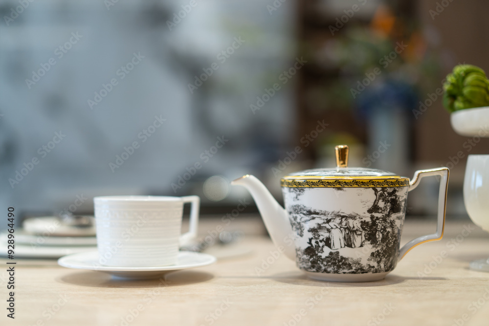 cup and tea pot on table cup and tea pot on table