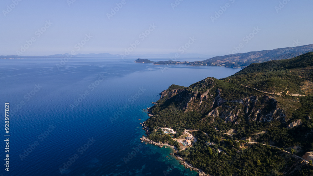 Obraz premium Aerial view of expensive residential houses in island small town Syvota Greece. American dream homes as example of real estate development in US suburbs