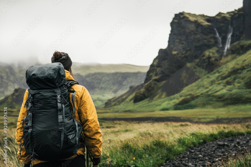 Backpacker exploring lush, misty mountain valley area. Backpacker exploring lush, misty mountain valley area.