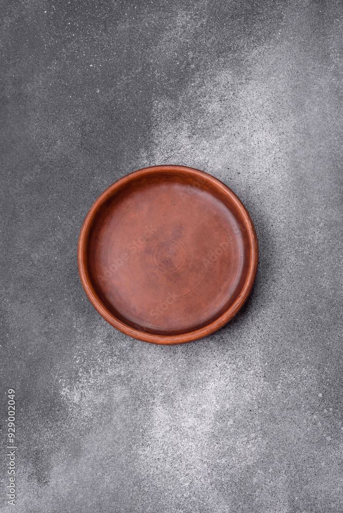 Empty ceramic plate on a dark textured background